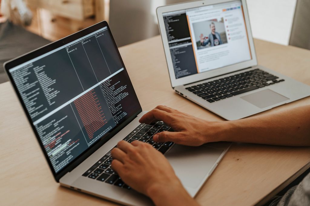Developer Tools News Today A developer working on a laptop, typing code, showcasing programming and technology skills.
