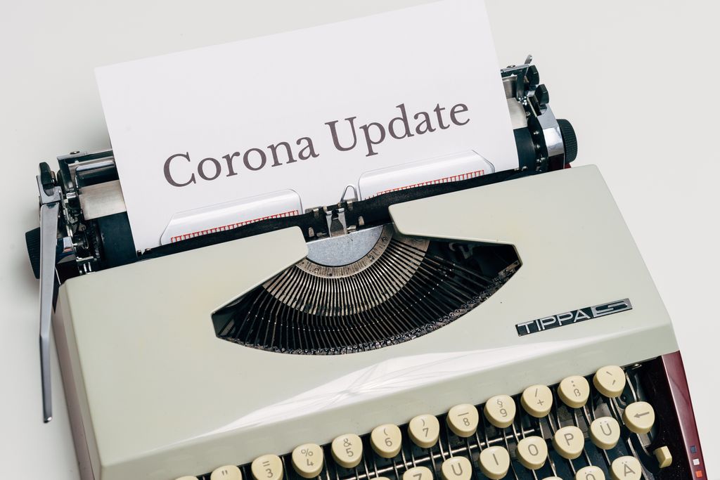 UploadBlog.com Online Posting A vintage typewriter displaying a page with the words 'Corona Update' typed on it.