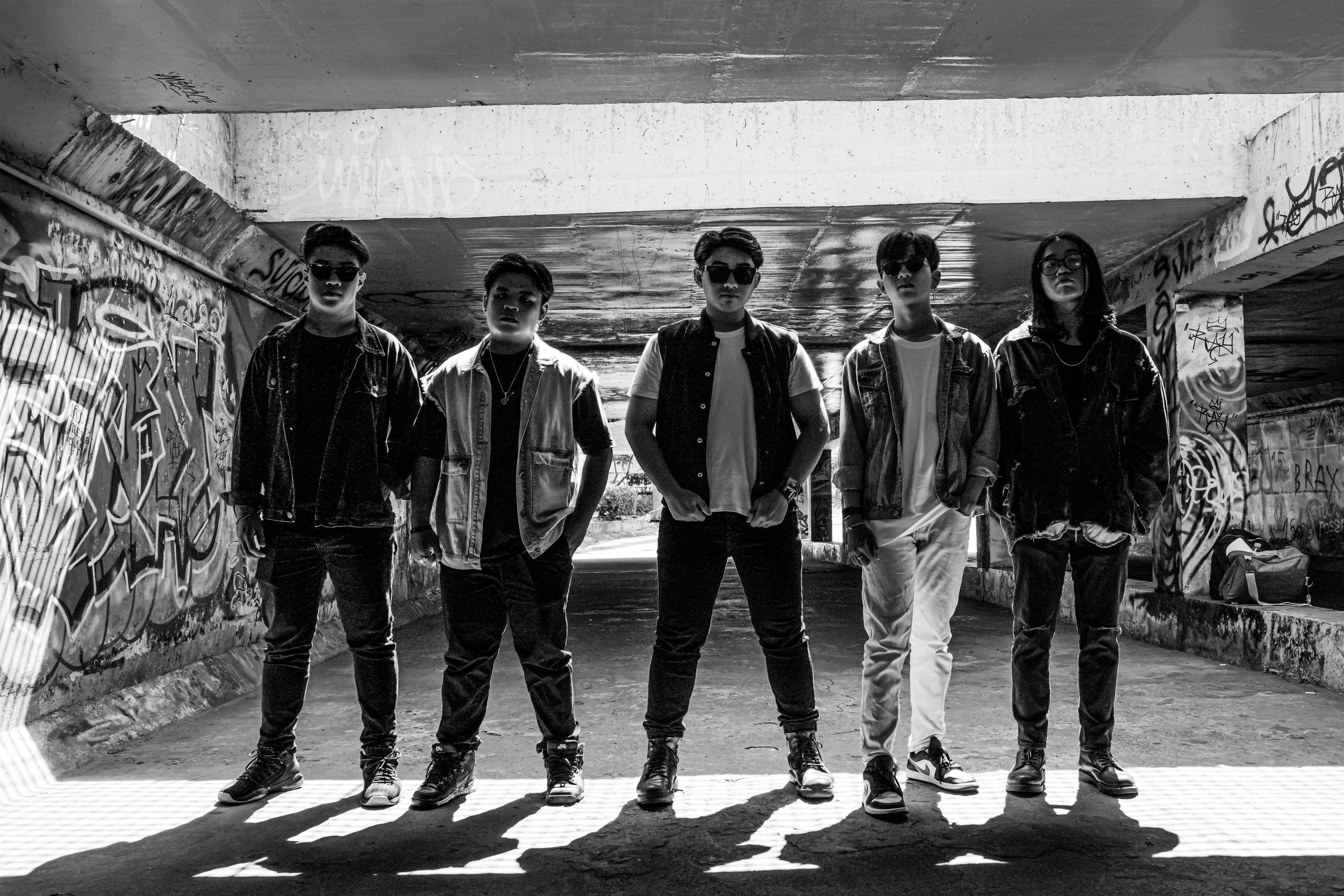 TheUploadArticleBlog.com Black and white photo of a group of teenagers standing in an underground graffiti-covered tunnel.