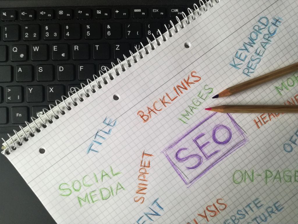 UploadBlog.com Content Marketing Close-up of notebook with SEO terms and keywords, highlighting digital marketing strategy.
