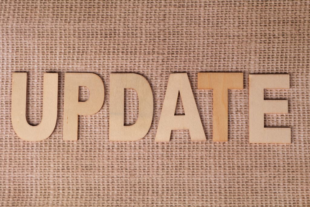 UploadBlog Content Wooden letters arranged to spell 'UPDATE' on a textured burlap surface, perfect for business or project imagery.
